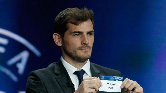 File - In this Aug. 28, 2014 file photo, Real Madrid goalkeeper Iker Casillas shows the name of Porto during a UEFA Champions League draw at the Grimaldi Forum, in Monaco. Casillas is leaving Real Madrid to join Portuguese club FC Porto after 16 seasons in which he helped the Spanish powerhouse win three Champions League titles, five Spanish leagues and two Copas del Rey. (AP Photo/Claude Paris, File)